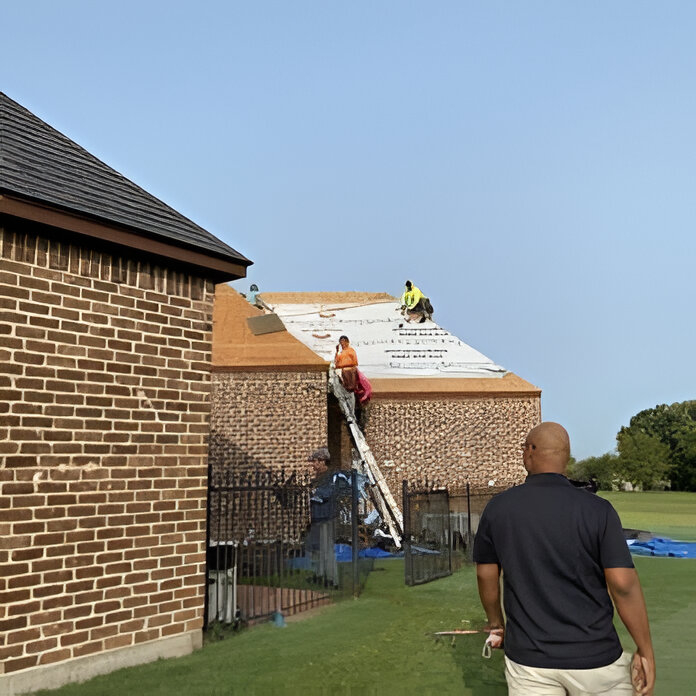 Workers working on the roof for applying the sheets